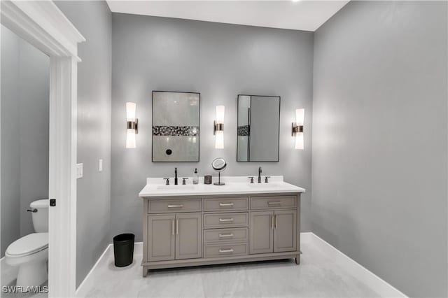 bathroom featuring vanity and toilet