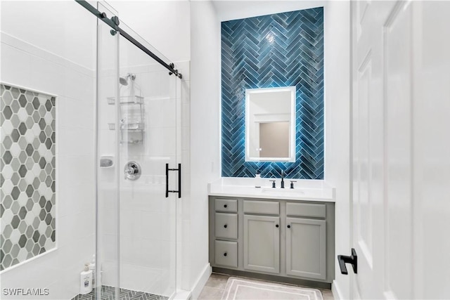 bathroom featuring vanity, an enclosed shower, and tile walls