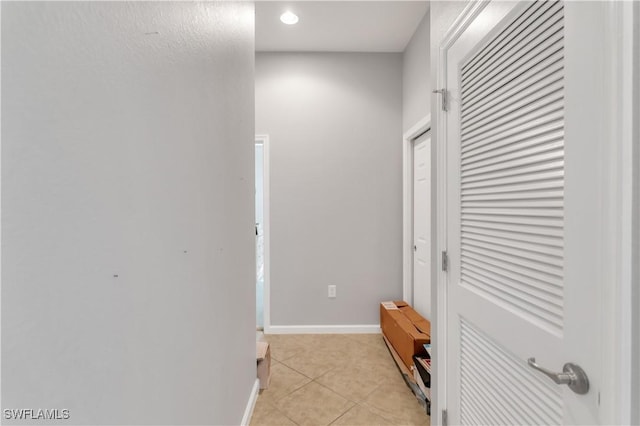 corridor featuring light tile patterned floors