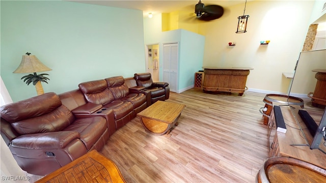 living room with light wood-type flooring and ceiling fan