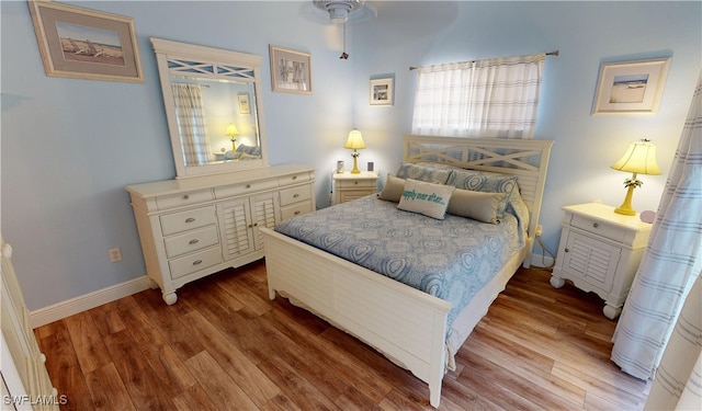 bedroom featuring hardwood / wood-style floors and ceiling fan