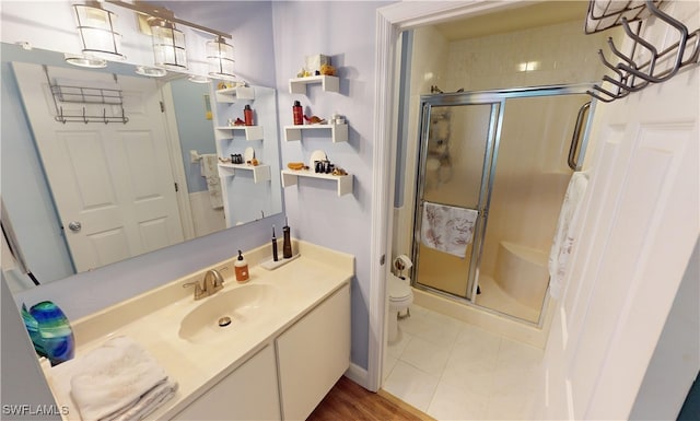 bathroom with walk in shower, tile patterned floors, vanity, and toilet