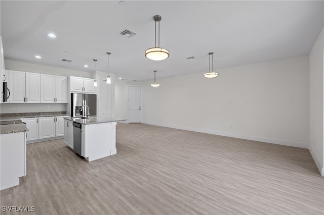 kitchen with stainless steel appliances, light wood-type flooring, white cabinets, and baseboards