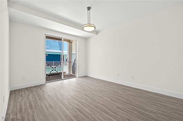 unfurnished room featuring wood finished floors and baseboards