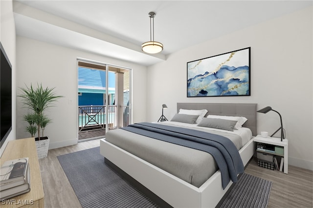 bedroom with access to exterior, light wood-style flooring, and baseboards