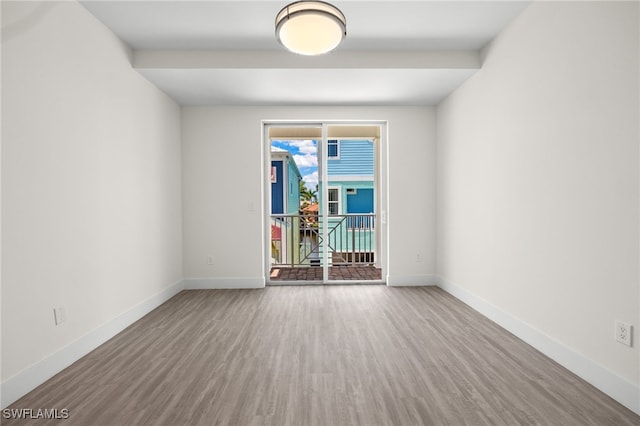 unfurnished room featuring wood finished floors and baseboards