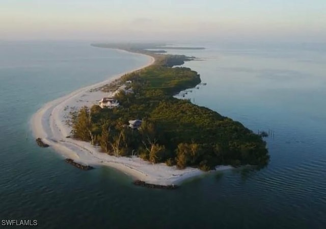 drone / aerial view featuring a water view and a beach view