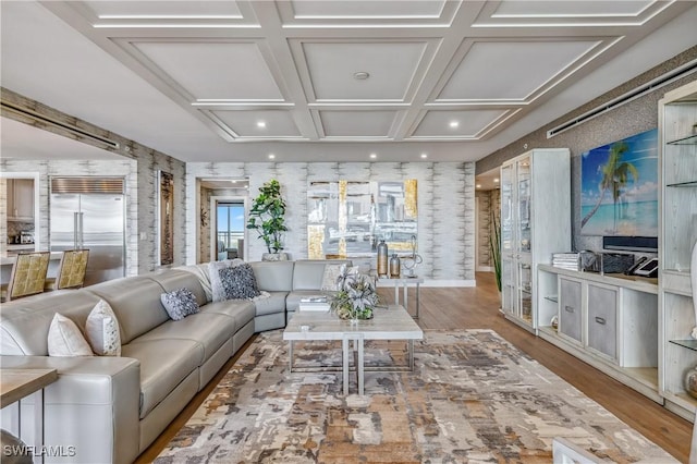 living room with beam ceiling, light wood-type flooring, and coffered ceiling