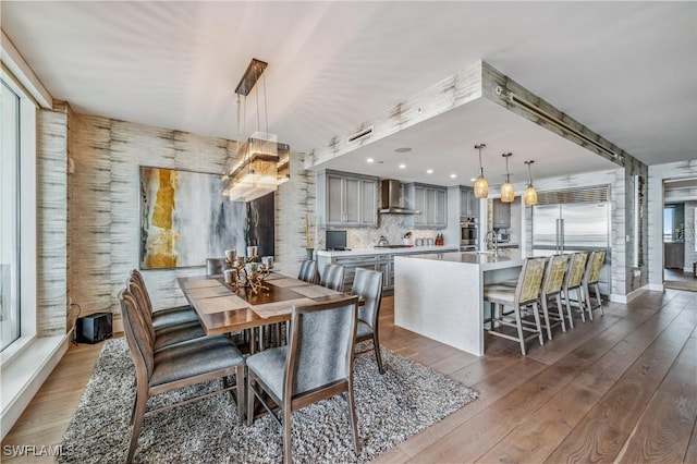 dining space with dark hardwood / wood-style flooring and sink