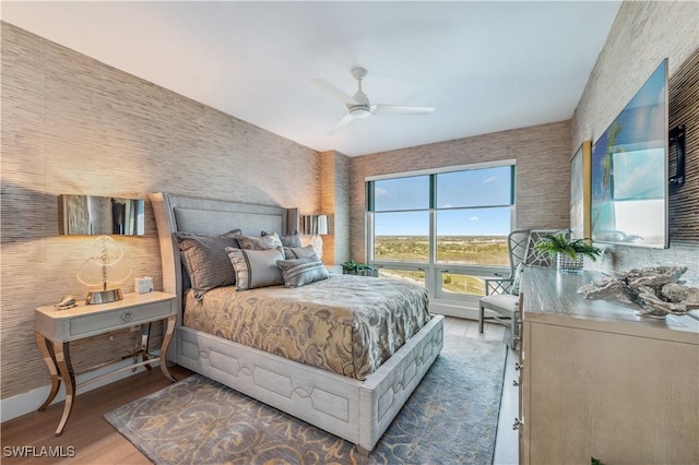 bedroom with hardwood / wood-style floors and ceiling fan