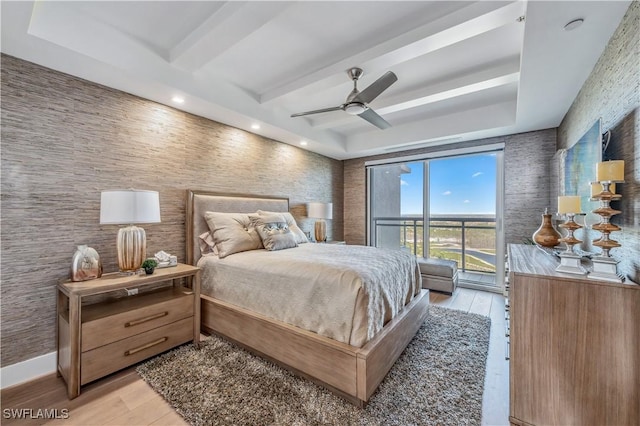 bedroom with access to outside, ceiling fan, light hardwood / wood-style flooring, and beam ceiling