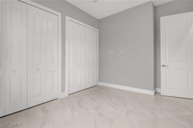 unfurnished bedroom featuring multiple closets