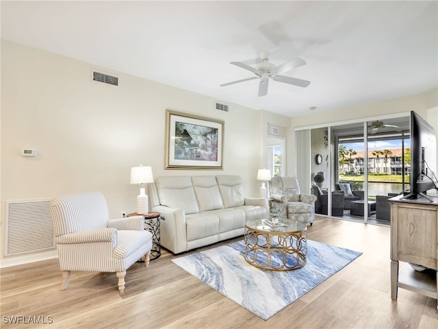 living room featuring light wood-type flooring and ceiling fan