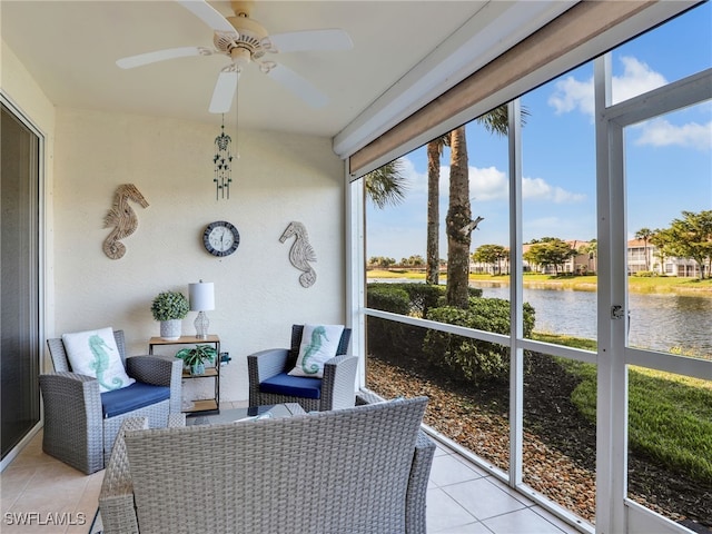 sunroom with ceiling fan, a water view, and plenty of natural light