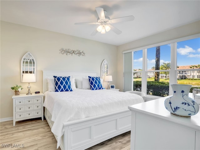 bedroom with ceiling fan and light hardwood / wood-style flooring