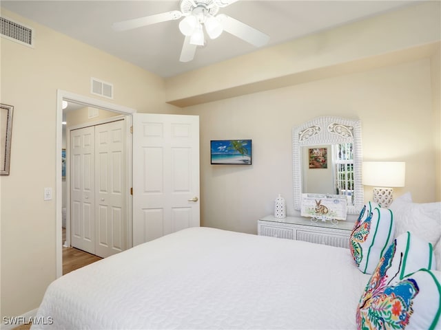 bedroom with ceiling fan and a closet