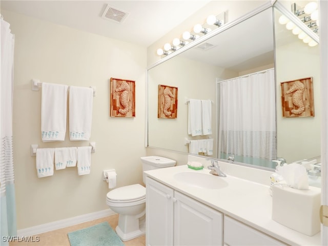 bathroom with toilet, vanity, and tile patterned floors