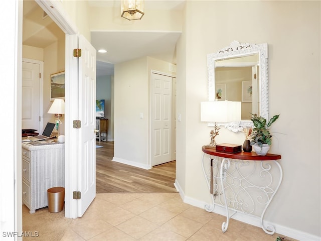 hall featuring light tile patterned floors