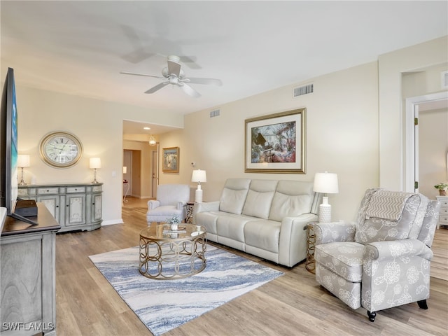 living room with light hardwood / wood-style floors and ceiling fan