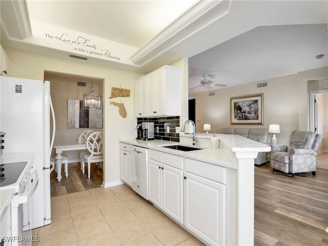 kitchen with white appliances, kitchen peninsula, white cabinetry, ceiling fan, and sink