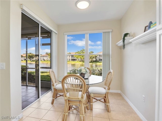 sunroom with a water view and plenty of natural light