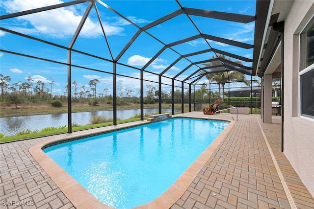 view of pool with glass enclosure, a water view, and a patio