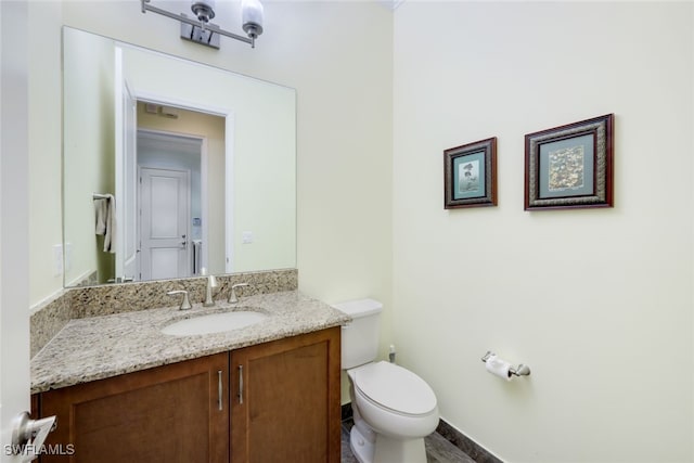 bathroom with toilet and vanity