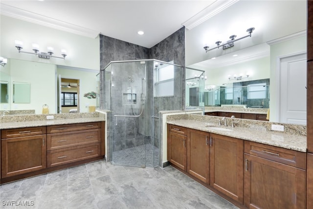 bathroom featuring vanity, ornamental molding, and walk in shower