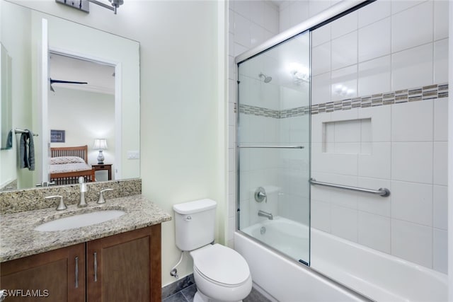 full bathroom with toilet, vanity, and combined bath / shower with glass door