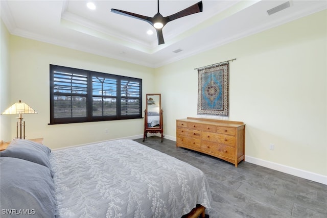 bedroom featuring ceiling fan, crown molding, and a tray ceiling