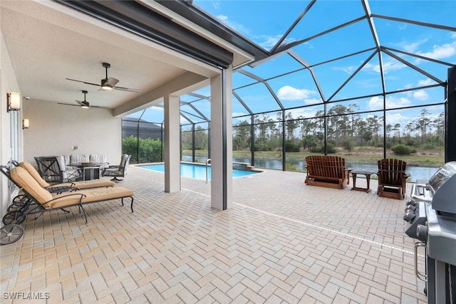 view of patio featuring a lanai, a water view, grilling area, and ceiling fan