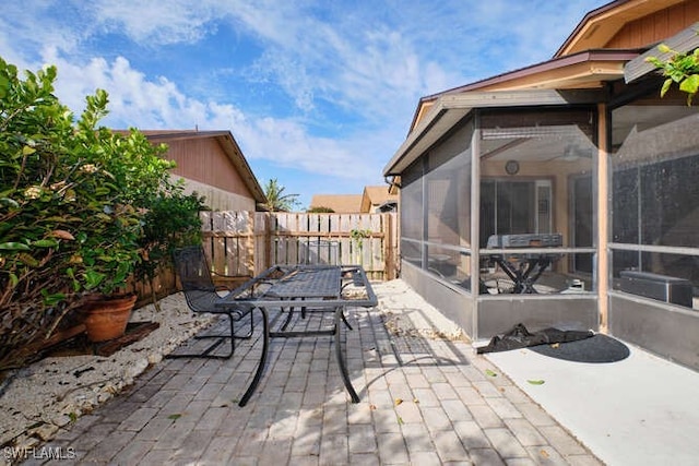 view of patio / terrace featuring a sunroom