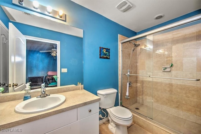 bathroom featuring ceiling fan, vanity, an enclosed shower, and toilet