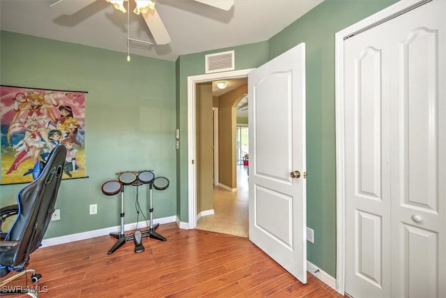 office space with light hardwood / wood-style flooring and ceiling fan