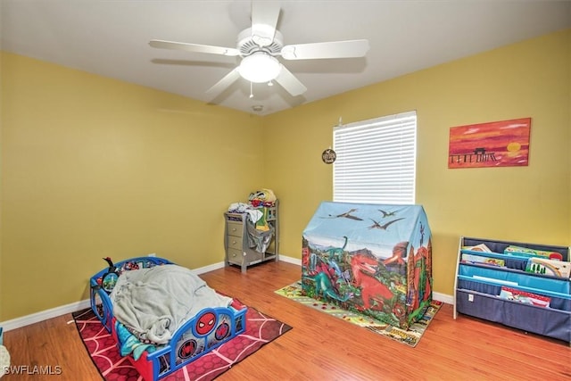 playroom featuring hardwood / wood-style flooring and ceiling fan