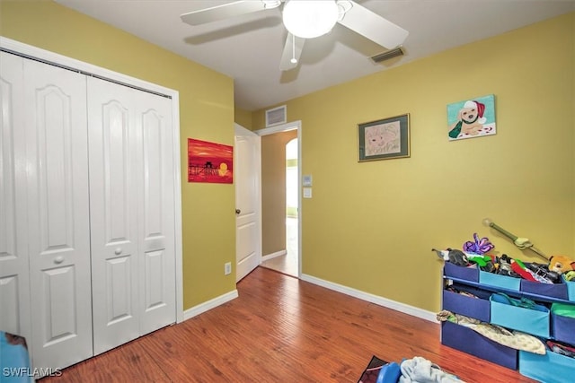 game room with hardwood / wood-style flooring and ceiling fan