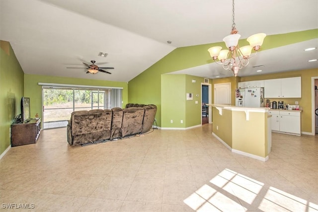 living room with ceiling fan with notable chandelier and vaulted ceiling