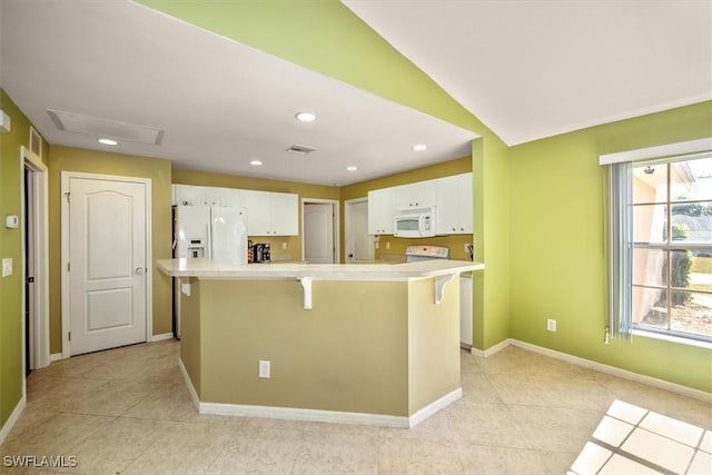 kitchen featuring white cabinetry, a center island, vaulted ceiling, white appliances, and a kitchen bar