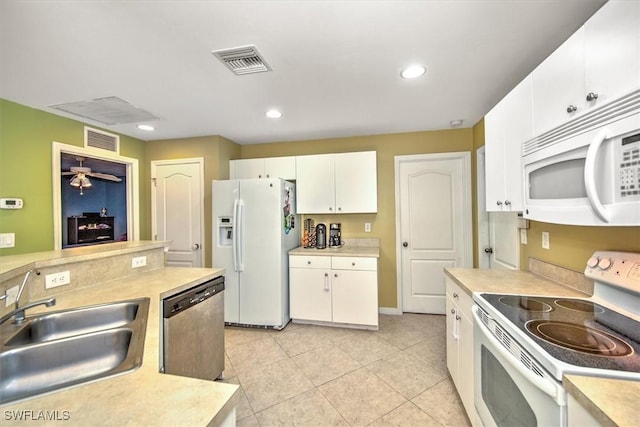 kitchen featuring white appliances, ceiling fan, sink, light tile patterned floors, and white cabinets