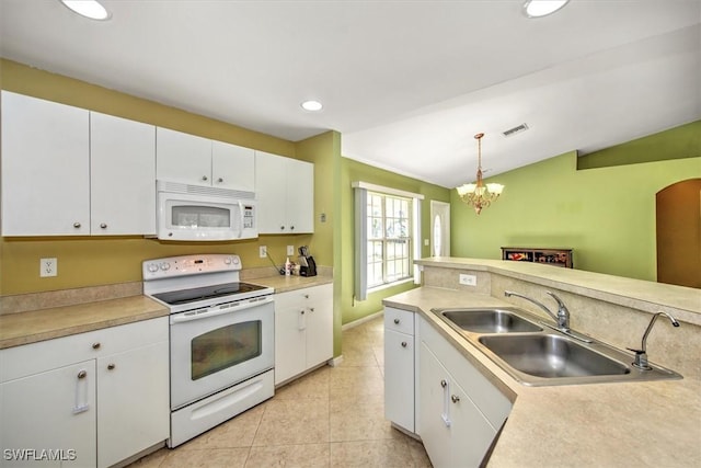 kitchen with vaulted ceiling, white cabinetry, decorative light fixtures, and white appliances