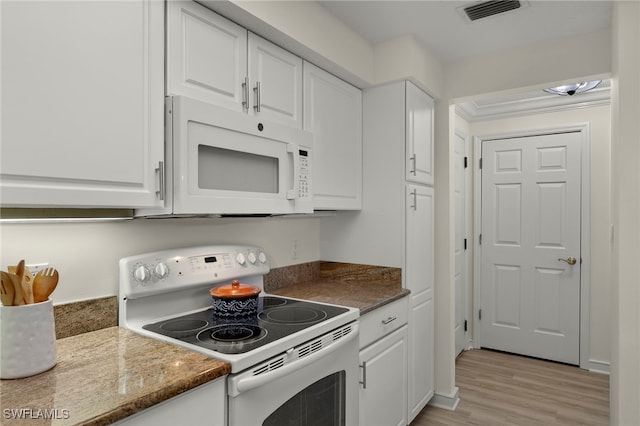 kitchen featuring white appliances, white cabinetry, dark stone countertops, and light wood-type flooring