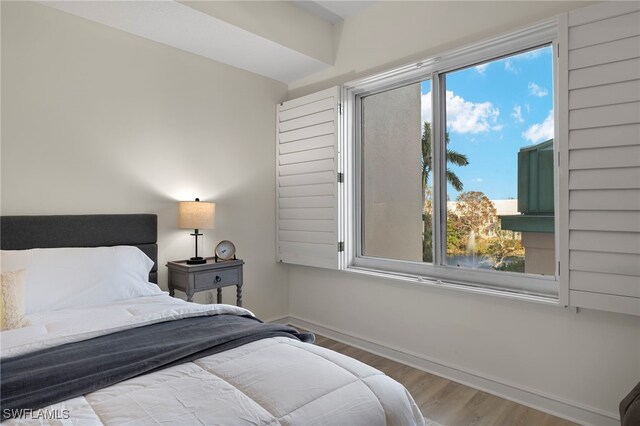 bedroom featuring hardwood / wood-style floors and multiple windows