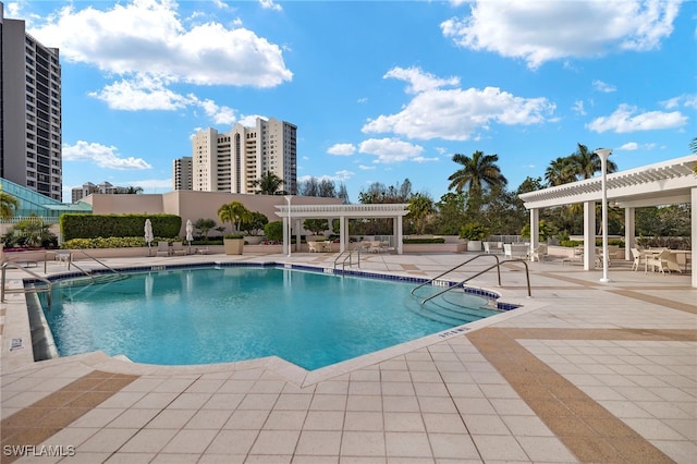 view of swimming pool with a patio area and a pergola