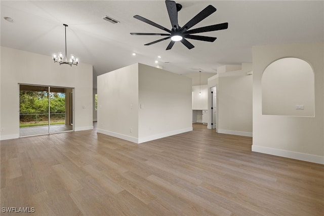 unfurnished living room with light hardwood / wood-style floors and ceiling fan with notable chandelier