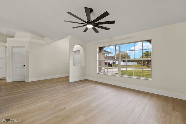 unfurnished living room with ceiling fan, light hardwood / wood-style flooring, and vaulted ceiling