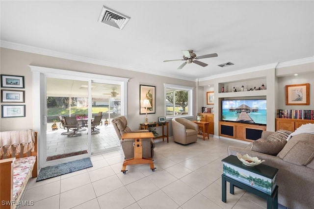 tiled living room with ceiling fan, built in features, and crown molding