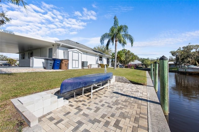 view of patio featuring a boat dock, a water view, and central AC unit