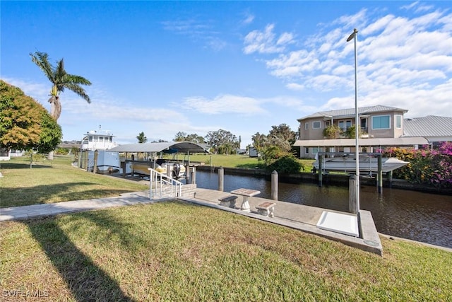 view of dock with a yard and a water view