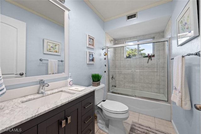 full bathroom featuring combined bath / shower with glass door, tile patterned floors, crown molding, toilet, and vanity