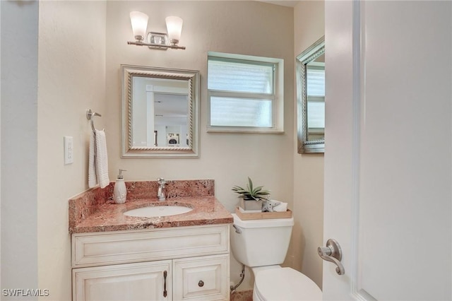 bathroom with toilet and vanity